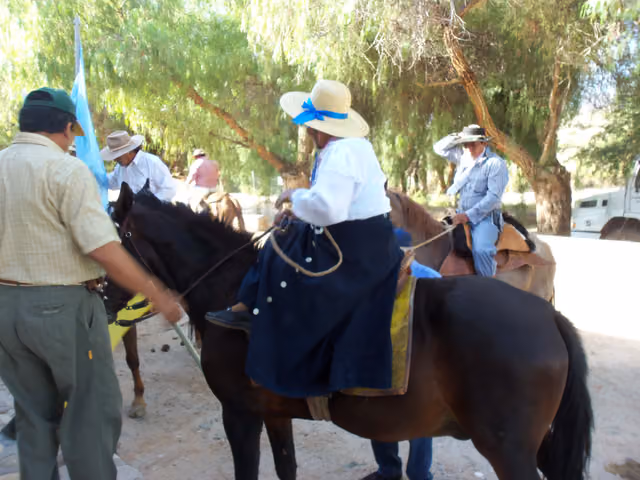Alférez mounting her horse, Molinos patron saint festivities