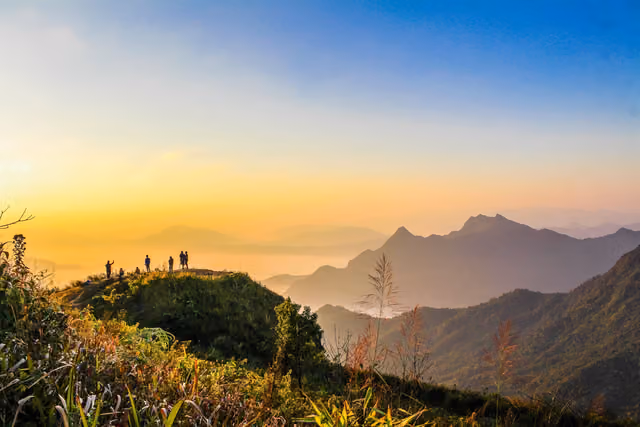 People on a mountain among grasses