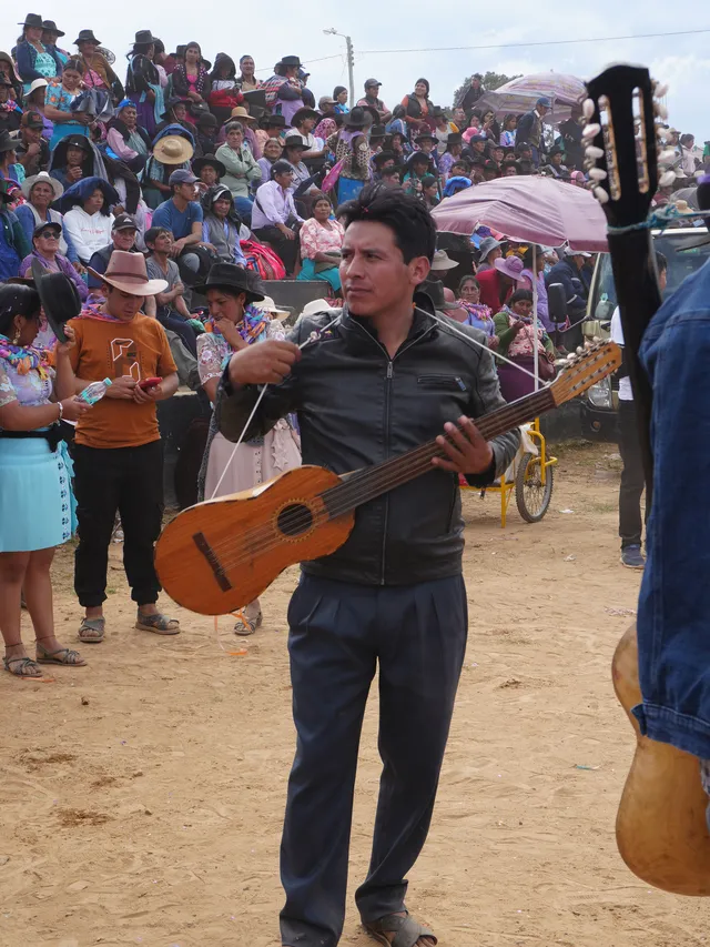 Musician with carnival bass or baritone charango during the Gran Pukara of Tarabuco