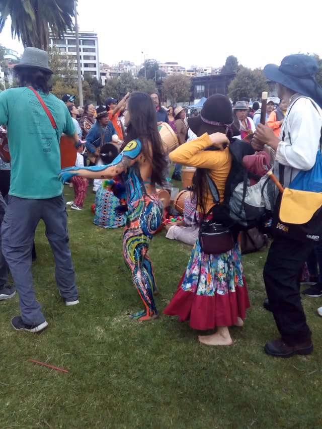 Musicians and dancers in a circle in a Quito park