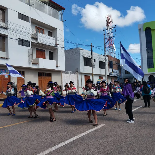 Women dancing sikuris during the retreta in the main square of Huancané