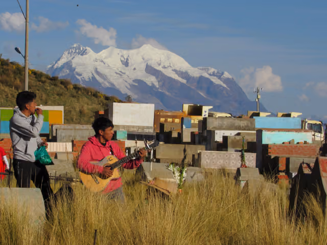 Young people playing music for the All Saints' prayer at the Villa Ingenio cemetery