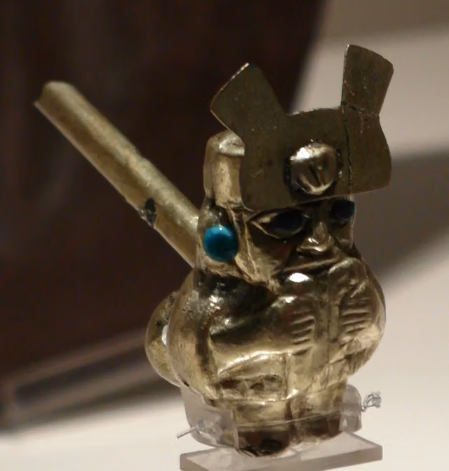 Moche gold whistle with a priest playing the antara