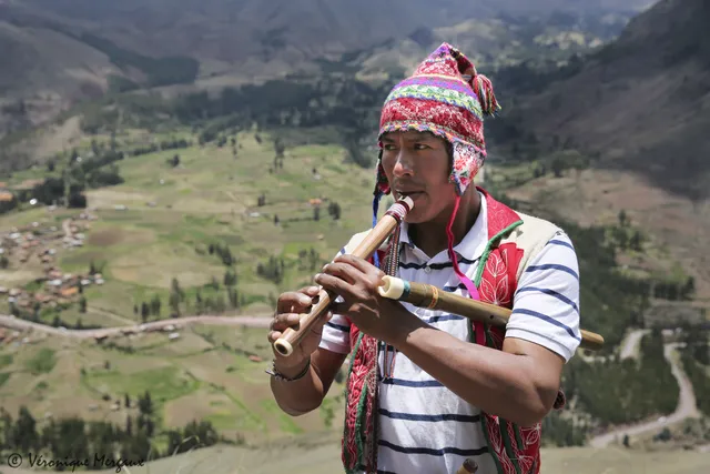 Amerindian man playing the quena (Inca flute)