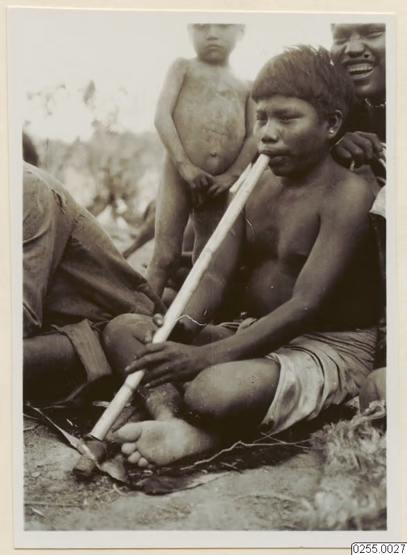 Tapiete boy playing a mouth flute (Bolivian Chaco, 1932)