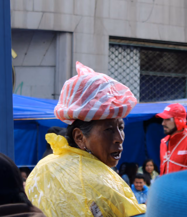Cholita with hat in the rain, Jisk'a Anata Carnival 2024