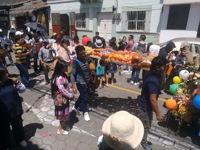 Indigenous people of La Esperanza, Imbabura, Ecuador, carrying an offering of produce at Inti Raymi