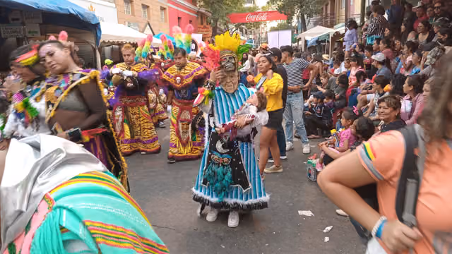Tobas achachi with a baby (Bolivian carnival)