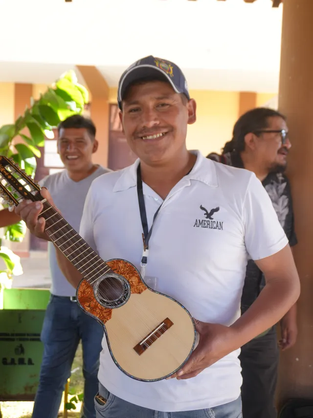 Charango builder showing his instrument at the Charango Museum, Aiquile 2025