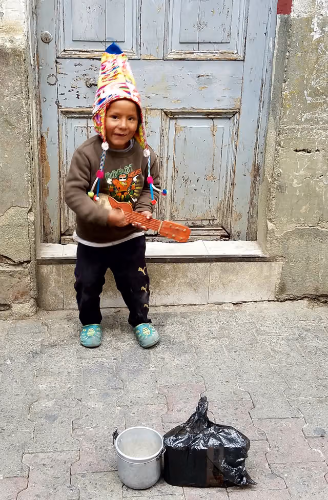 Child playing an instrument for money