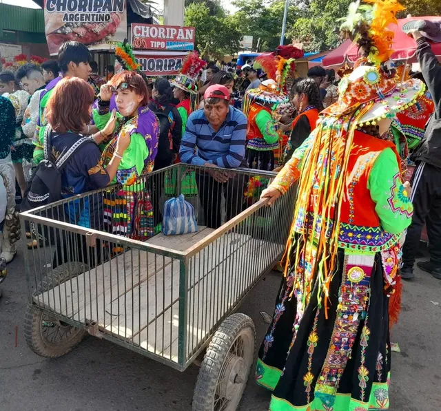 Cochabamba - Bolivia - Man with his cart and tinku dancers around