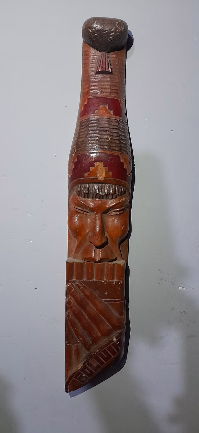 Carved monolith playing a zampoña